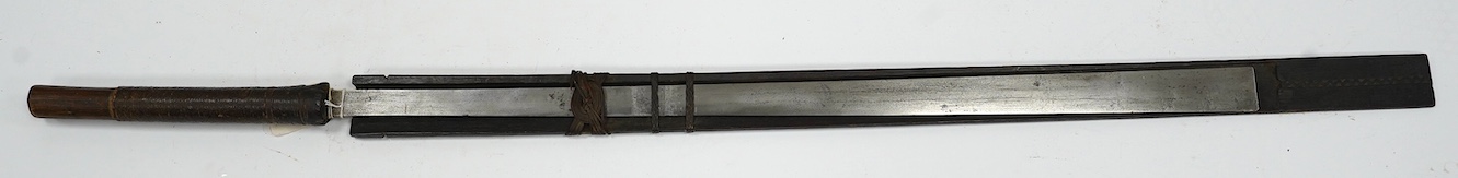 A 19th century Naga sword Dao, rattan bound wooden hilt in its open fronted wooden scabbard, blade 77cm. Condition - fair, some wear overall